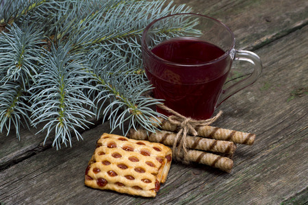 cup of tea a fir-tree branch and cookiesの写真素材