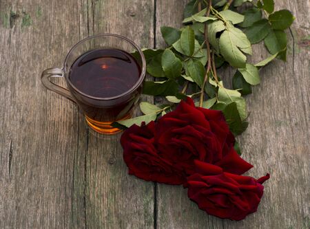 cup of tea and three red beautiful roses, still life, card, subject drinksの写真素材