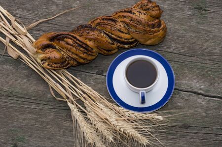 roll, grain ears and cup of coffee, still life on a subject food and drinksの写真素材
