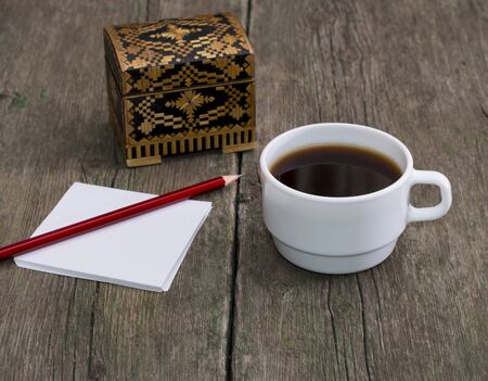 cup of coffee, pencil with paper and a casket, a still life, a subject drinksの写真素材