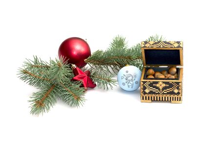 the fir-tree branch decorated with spheres and casket with forest nutlets, isolate, a subject holidays Christmas and New Yearの写真素材