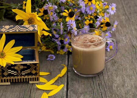 bouquet of flowers, cappuccino, casket and petals, subject flowers and drinksの写真素材