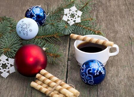 the fir-tree branch decorated with spheres and a snowflake coffee and baking, a subject holidays Christmas and New Yearの写真素材