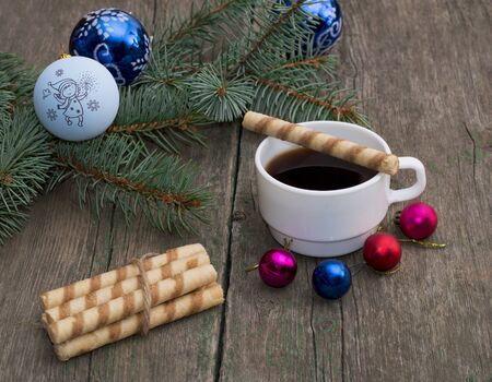 coniferous branch with an ornament, coffee and baking, the subject Christmas and New Yearの写真素材