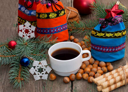 three gift bags, fir-tree branch, coffee and nutlets, subject Christmas and New Yearの写真素材