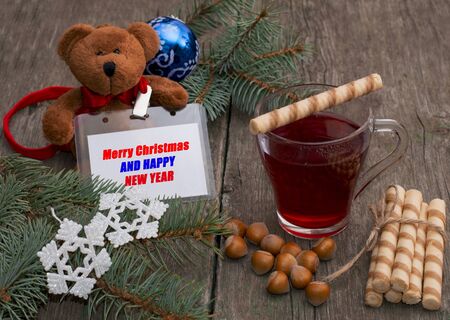 tea, baking, nutlets and a toy bear with a label, the subject Christmas and New Yearの写真素材