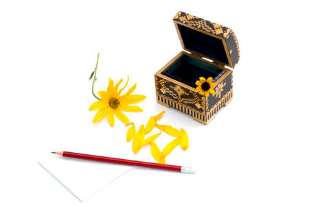 still life a casket, a pencil with paper and a yellow flower, isolate, a subject seasons spring,...