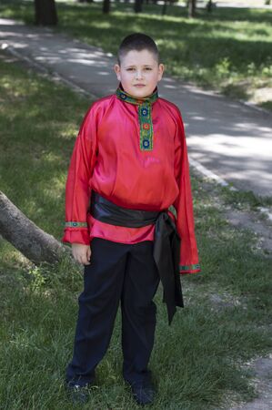 the boy in the Russian red shirt against park, a subject people and holidaysの写真素材