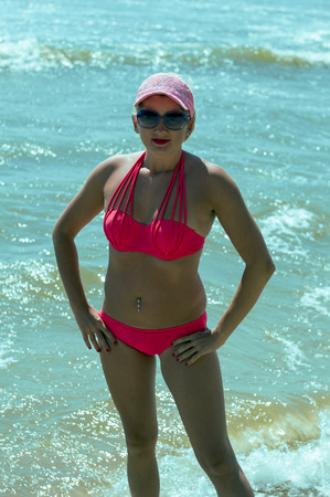 the woman in a bright bathing suit against the background of the sea, a subject beautiful women, sea tour, the resort, a holiday, vacationの写真素材