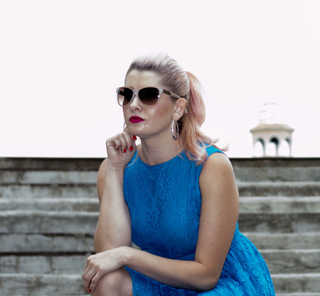 beautiful blonde sat down on the steps, the theme of beautiful bright womenの写真素材