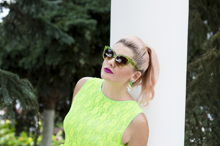 portrait of a beautiful woman in a green dress at the column, the theme of beautiful bright womenの写真素材