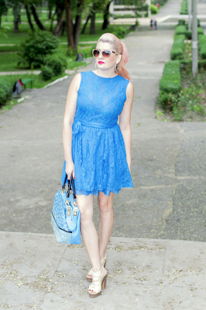 beautiful woman in blue walking in the Park, beautiful bright women themeの写真素材