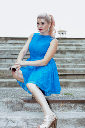 sexy blonde on the steps, beautiful bright women themeの写真素材