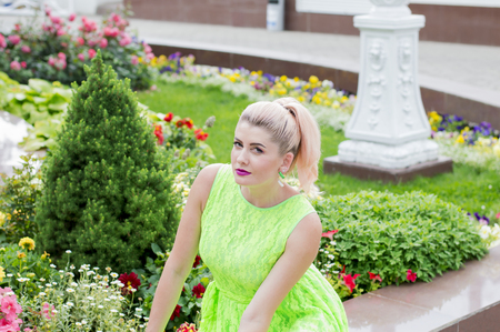 a woman sitting in the beautiful floral decorations, the theme of beautiful vibrant womenの写真素材
