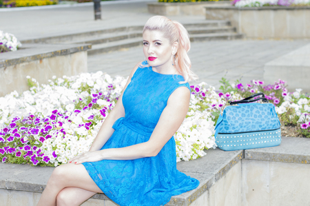 beautiful woman in flowerbeds with Petunia, the theme of beautiful vibrant womenの写真素材