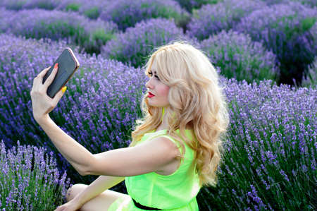 a woman in the middle of a lavender bush. flowers and womenの写真素材
