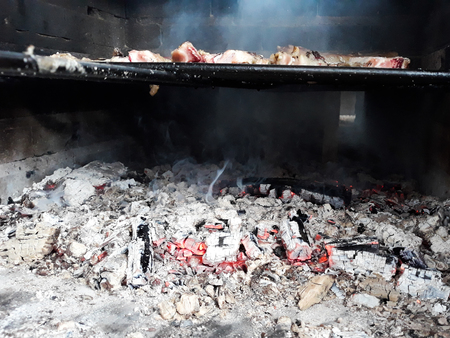 Grilled ribs and grilled meat over the fire, cooked to the embersの写真素材