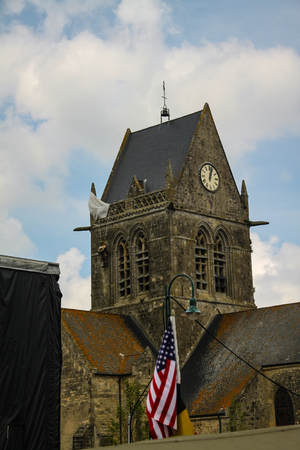 Normandy, France; 4 June 2014: The soldier landed on the steeple of the church of Sainte Mere Egliseのeditorial素材