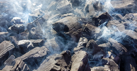 Smoke of the coal on the embers. Preparation of fire for barbecue embers. Outdoor recreation. No...
