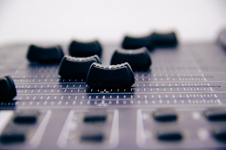 Audio mixer, mixing desk controls and fader, music mixing console with degraded effects for banners and backgroundsの写真素材
