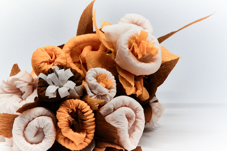 Bouquet of flowers made of couche gift paper insulated on a white and blurred background.の写真素材