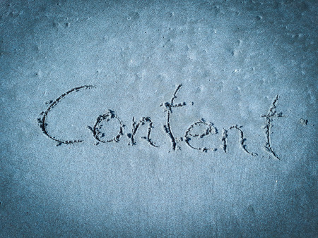 Content, word written on blue sandの写真素材