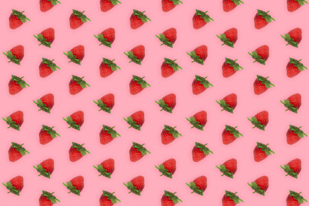 Pattern of fresh beautiful strawberries isolated on light pink background. Top view photo concept of...