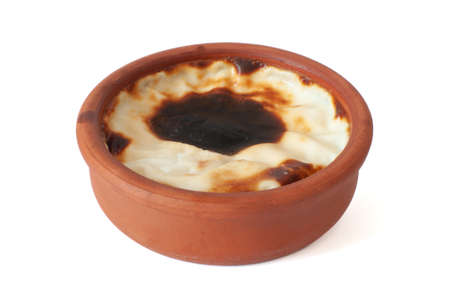Profile view of delicious baked rice pudding, traditional milky dessert known as in Turkish sutlac...