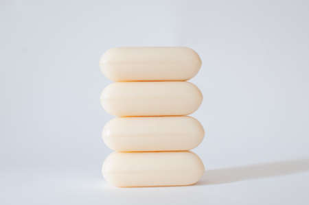 Soap bricks, vertical stack of four natural soap bars with profile view isolated on white background with selective focus. Hypoallergenic, without dyes and perfumes.の写真素材
