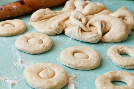 Mid section of a woman kneading dough in kitchen