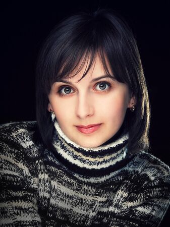 beautiful brunette on a dark backgroundの写真素材