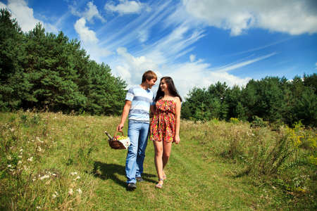 Couple laughing while going for a picnicの写真素材