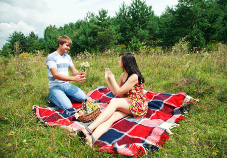 Beautiful, Happy Couple Having Romantic Picnic Together Outsideの写真素材