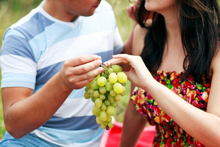Happy Couple Having Romantic Picnic Together Outsideの写真素材