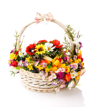 basket decorated with flowers on a white backgroundの写真素材