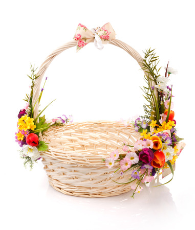 basket decorated with flowers on a white backgroundの写真素材