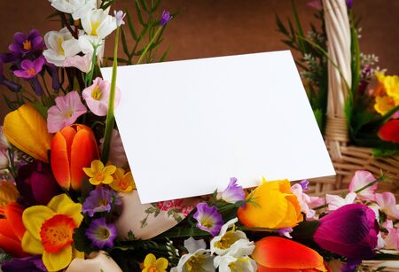 decorated flowers basket vith with blank greeting cardの写真素材