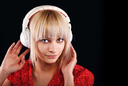 beautiful blonde girl listens to music in the headphonesの写真素材