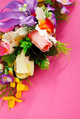 artificial flowers  on pink background with place for label advertisementの写真素材