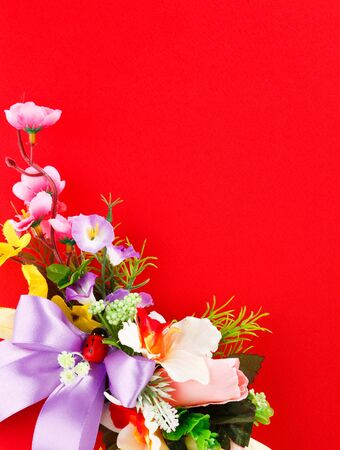 flower arrangement on a red background with space for greetingsの写真素材