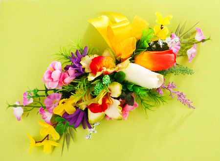 artificial flower arrangement on a yellow background with blank  for advertisementの写真素材