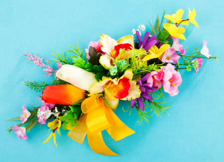 arrangement of artificial flowers on blue backgroundの写真素材