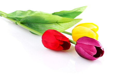three artificial tulips isolated on whiteの写真素材