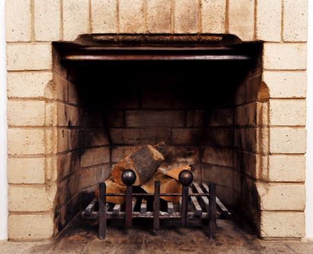 vintage antique fireplace with dry firewoodの写真素材