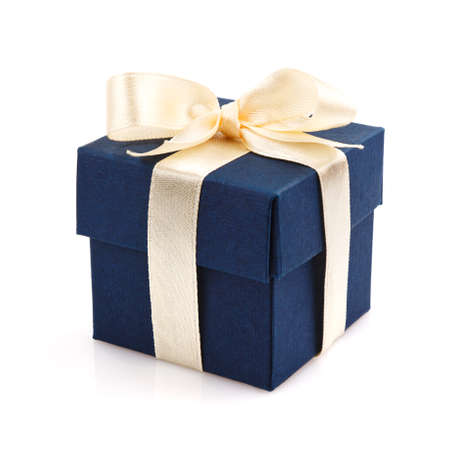 dark blue gift box with golden ribbon and bow isolated on whiteの写真素材
