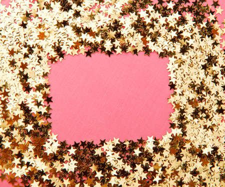 frame made of decorative stars on pink backgroundの写真素材