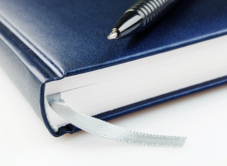 notebook with pen  on a white backgroundの写真素材