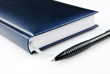 notebook with pen  on a white backgroundの写真素材