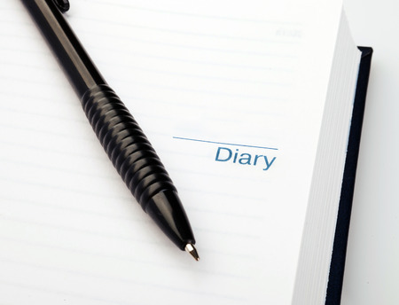 Open notebook with pen on clean sheetsの写真素材