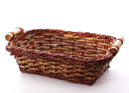 decorative wicker basket isolated on whiteの写真素材